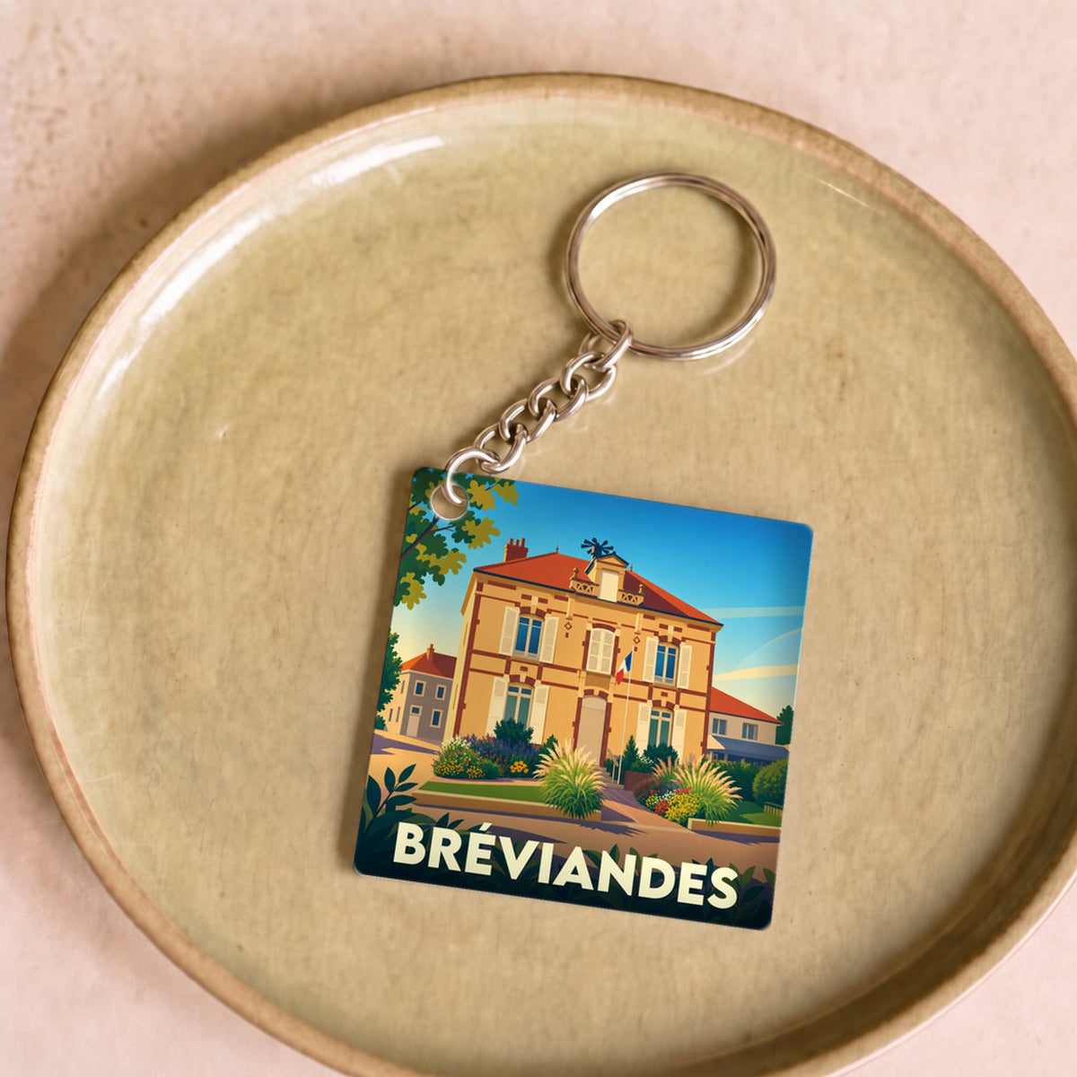 Porte-clés souvenir de la ville de Bréviandes avec une illustration stylisée.