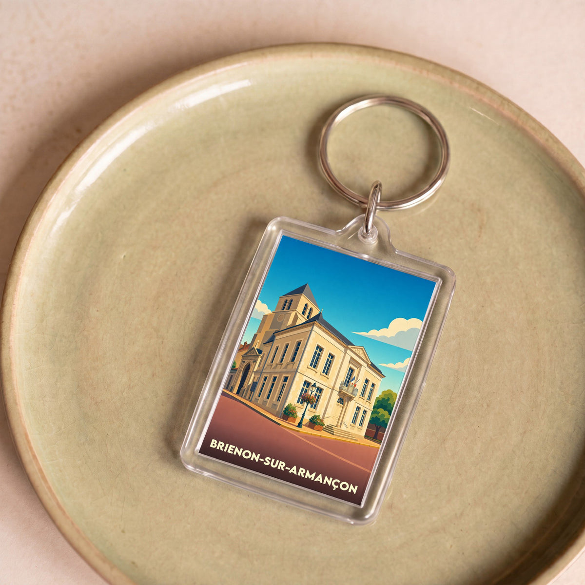 Porte-clés souvenir de la ville de Brienon-sur-Armançon avec une illustration stylisée.