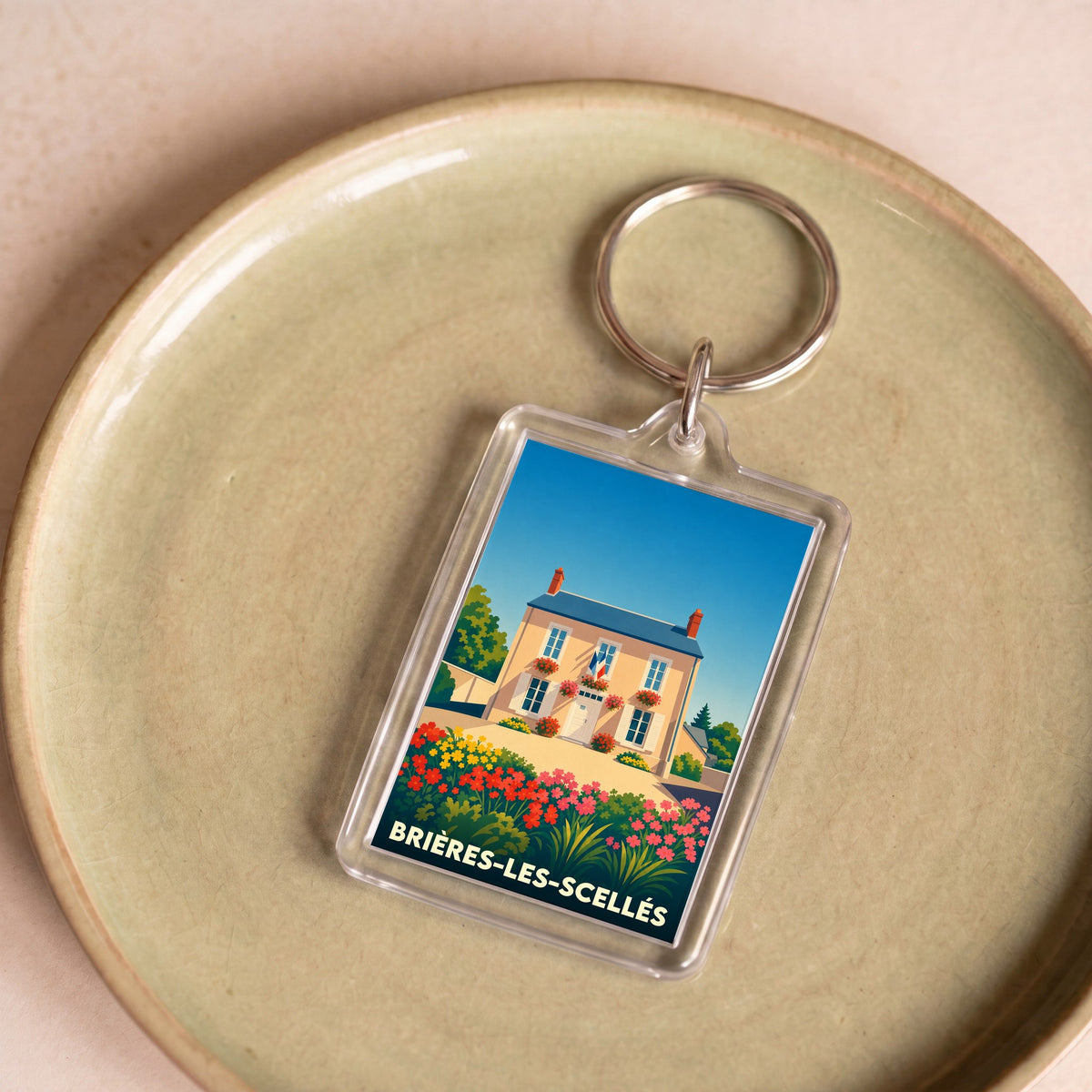 Porte-clés souvenir de la ville de Brières-les-Scellés avec une illustration stylisée.