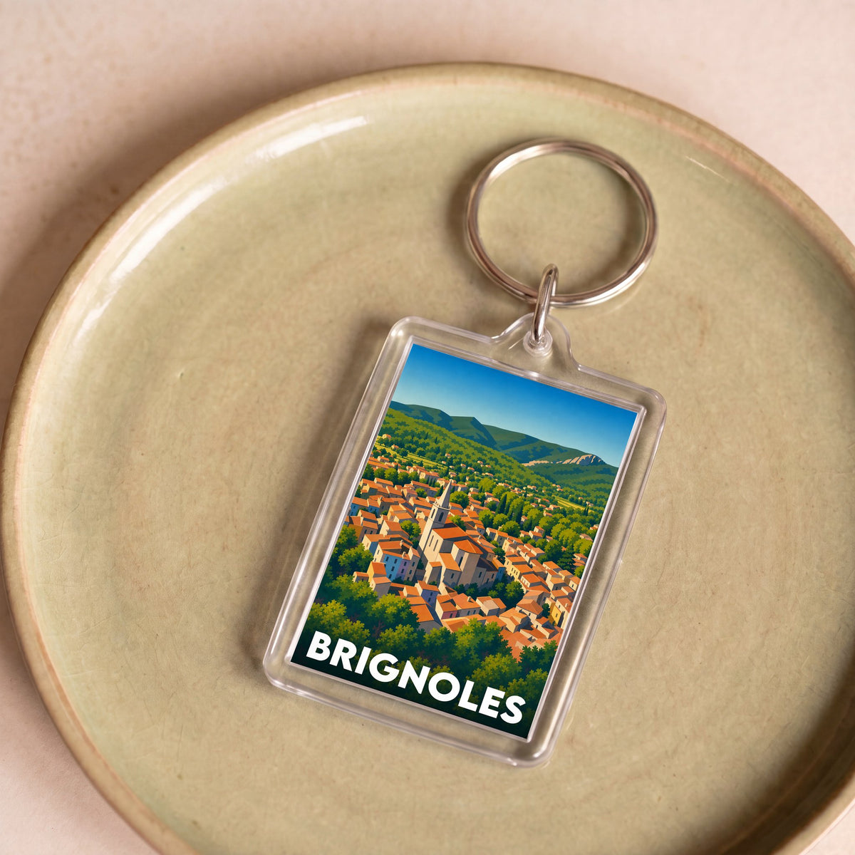 Porte-clés souvenir de la ville de Brignoles avec une illustration stylisée et colorée.