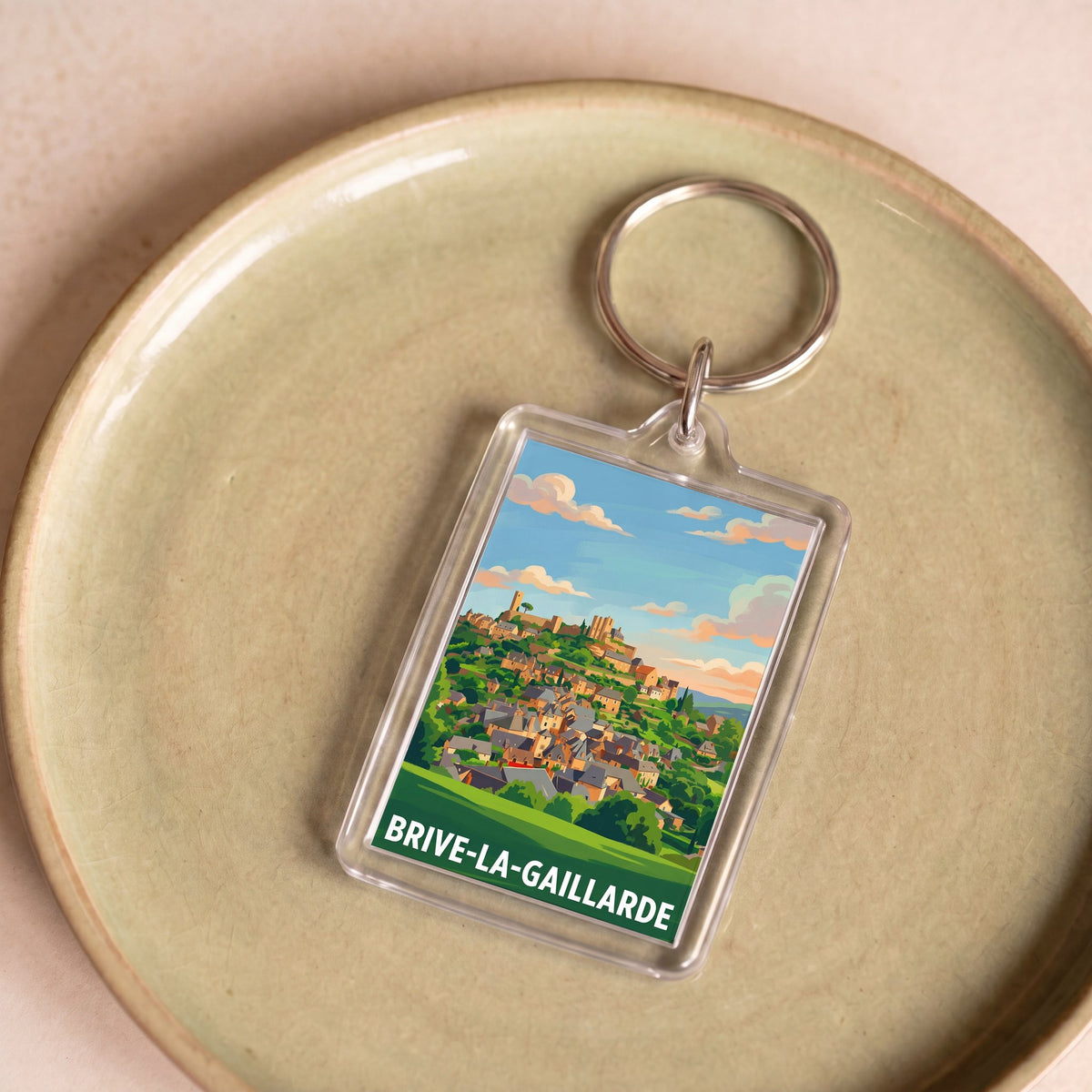 Porte-clés souvenir de la ville de Brive-la-Gaillarde avec une illustration stylisée.
