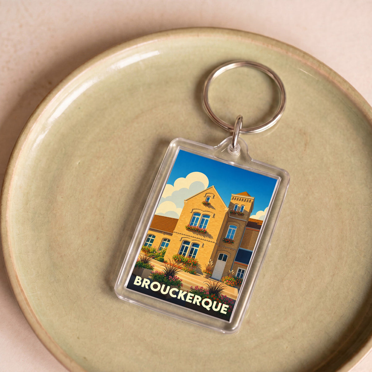 Porte-clés souvenir de la ville de Brouckerque avec une illustration stylisée.