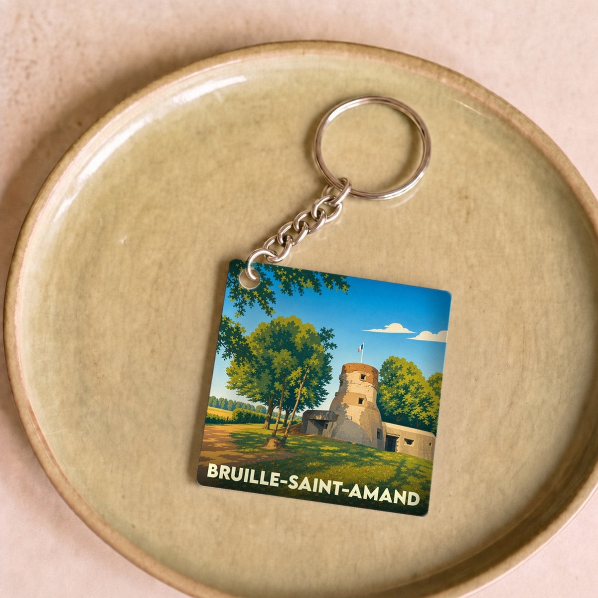 Porte-clés souvenir de la ville de Bruille-Saint-Amand avec une illustration stylisée.