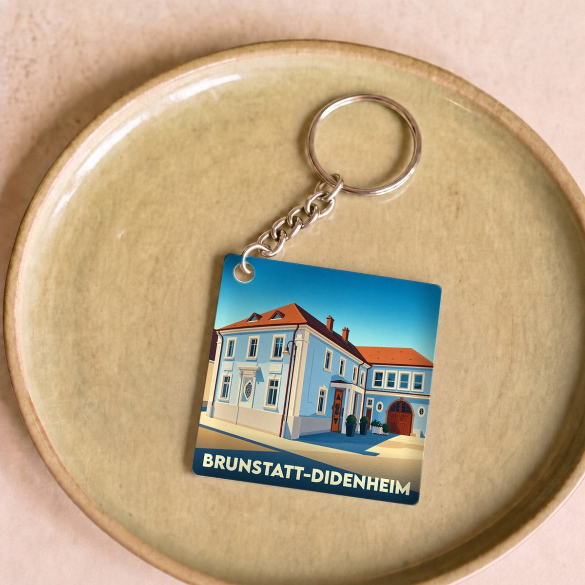 Porte-clés souvenir de la ville de Brunstatt-Didenheim avec une illustration stylisée.