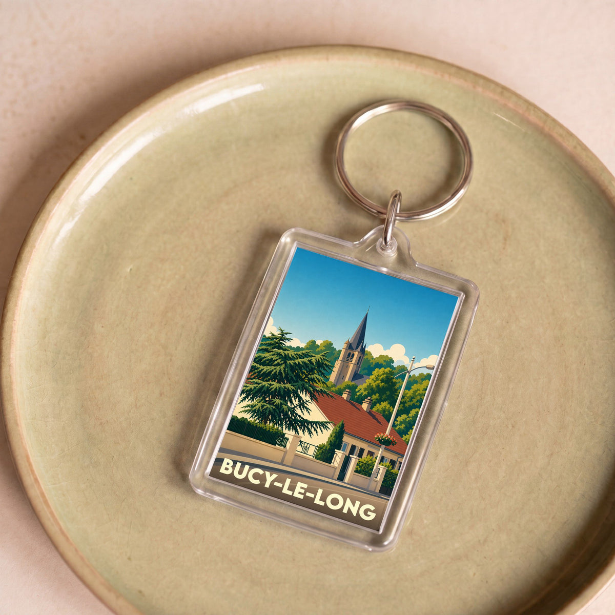 Porte-clés souvenir de la ville de Bucy-le-Long avec une illustration stylisée.