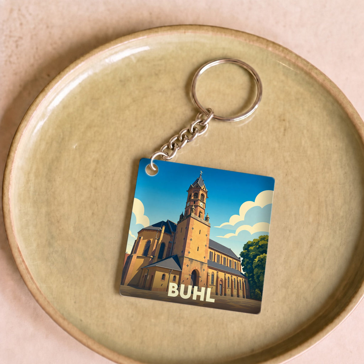 Porte-clés souvenir de la ville de Buhl avec une illustration stylisée de son église.