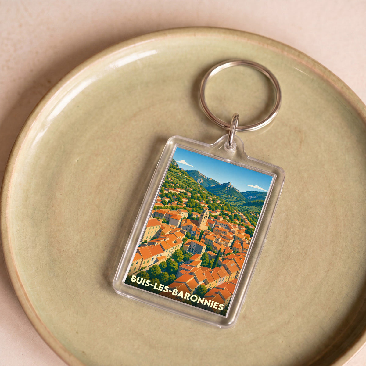 Porte-clés souvenir de la ville de Buis-les-Baronnies avec une illustration stylisée.