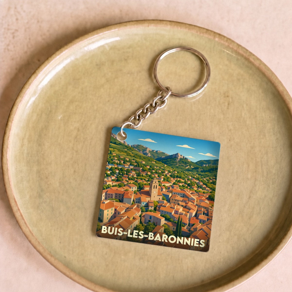 Porte-clés souvenir de la ville de Buis-les-Baronnies avec une illustration stylisée.