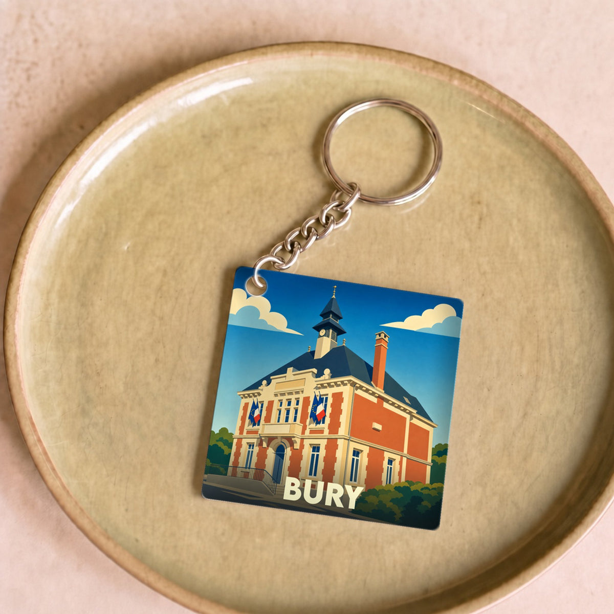 Porte-clés souvenir de la ville de Bury avec une illustration stylisée de son hôtel de ville.