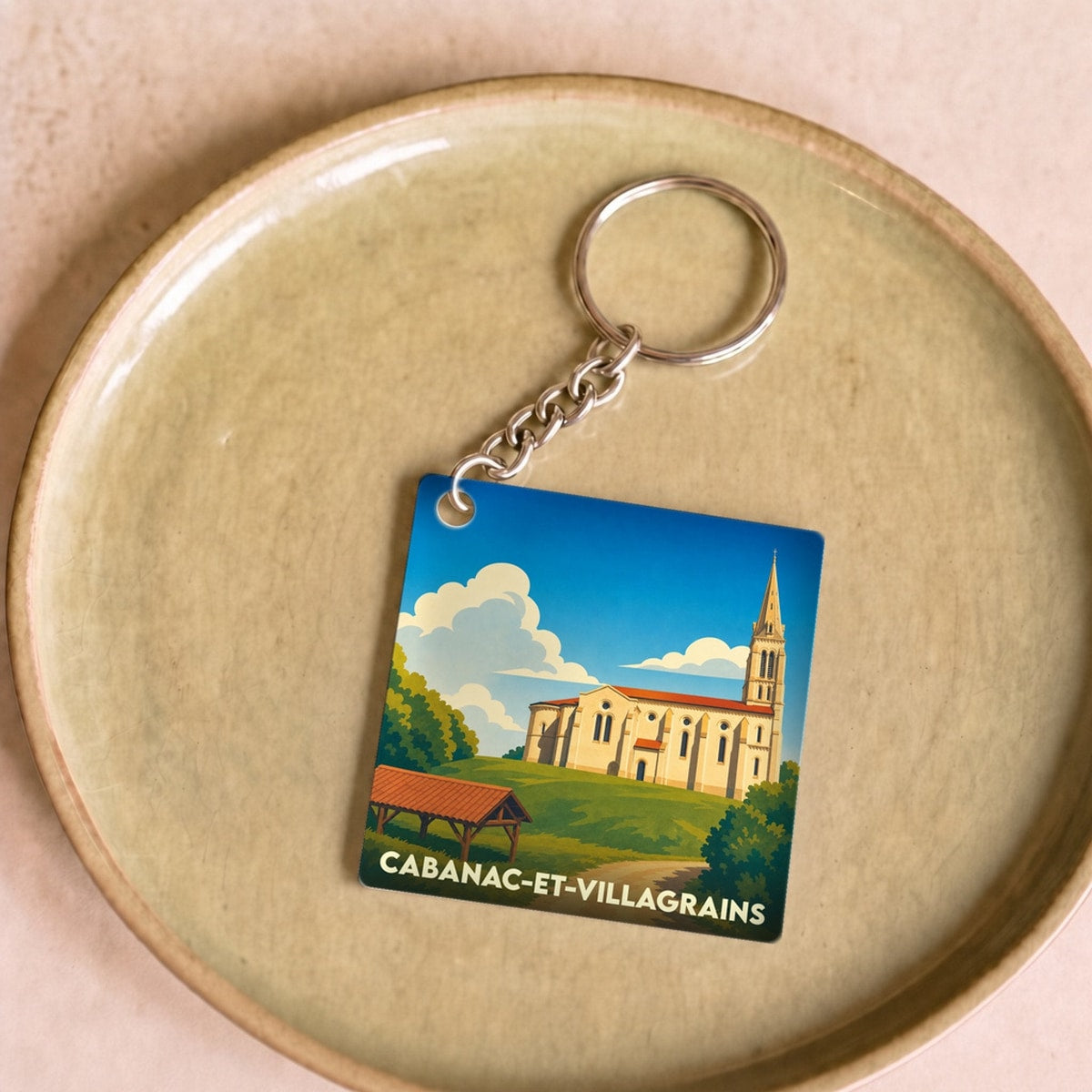 Porte-clés souvenir de la ville de Cabanac-et-Villagrains avec une illustration stylisée.
