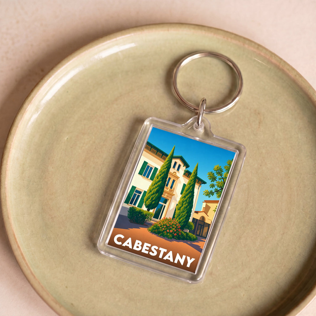 Porte-clés souvenir de la ville de Cabestany avec une illustration stylisée.