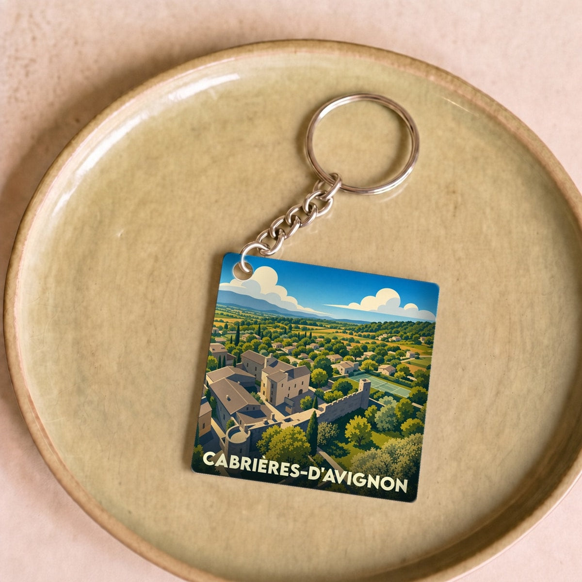 Porte-clés souvenir de la ville de Cabrières-d'Avignon avec une illustration stylisée.