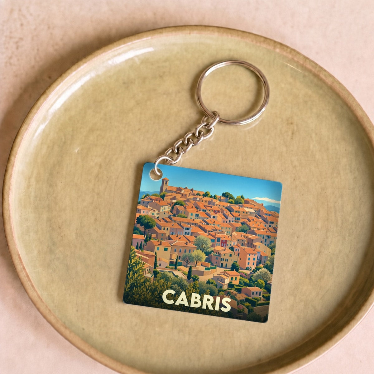 Porte-clés souvenir de la ville de Cabris avec une illustration stylisée.