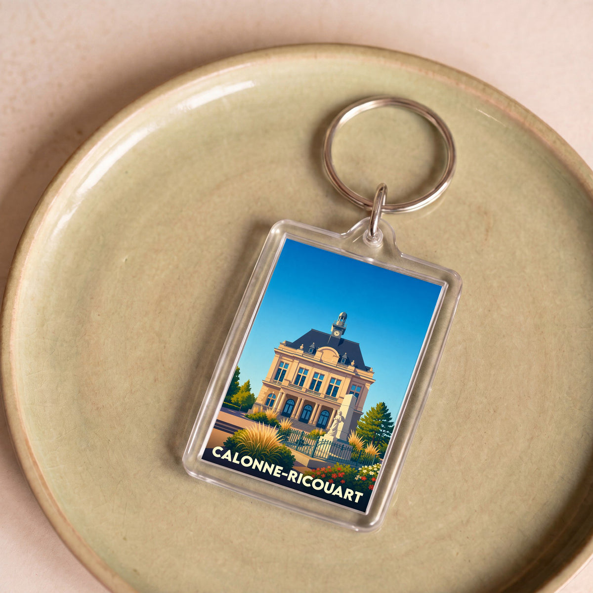 Porte-clés souvenir de la ville de Calonne-Ricouart avec une illustration stylisée de son hôtel de ville.