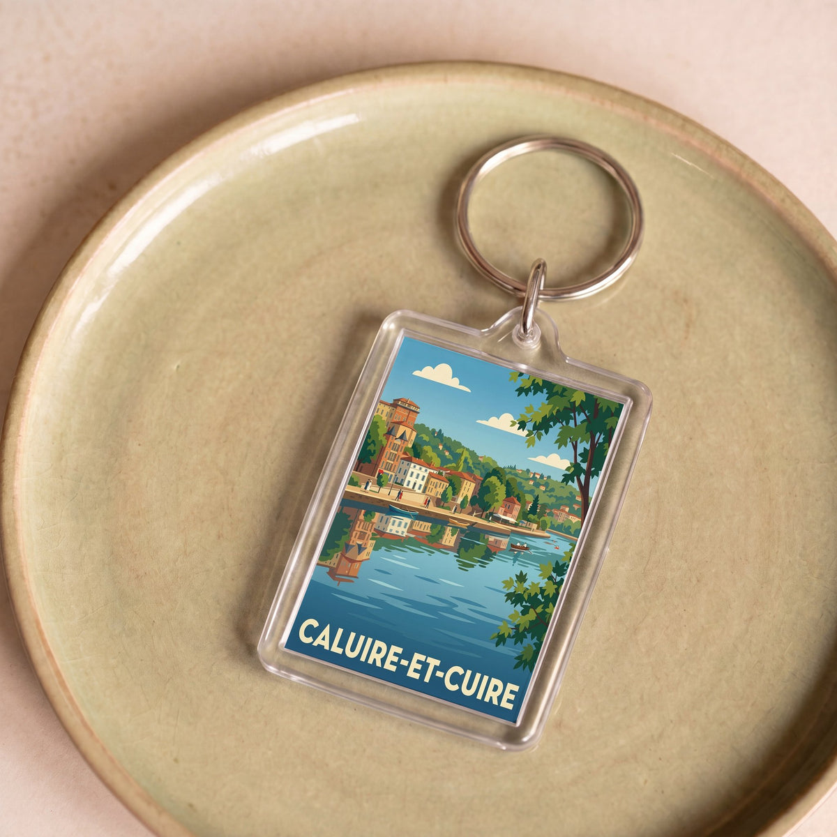 Porte-clés souvenir de la ville de Caluire-et-Cuire avec une illustration stylisée du paysage urbain.