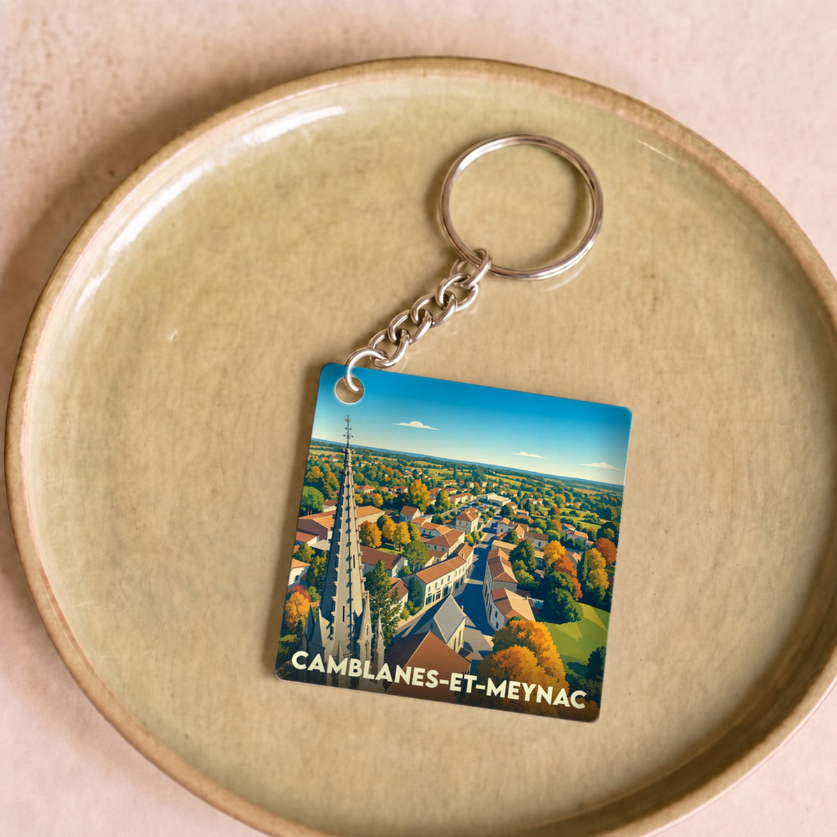 Porte-clés souvenir de la ville de Camblanes-et-Meynac avec une illustration stylisée.