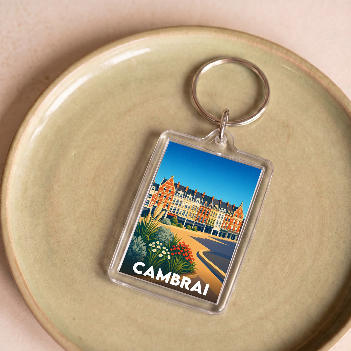 Porte-clés souvenir de la ville de Cambrai avec une illustration stylisée et colorée.