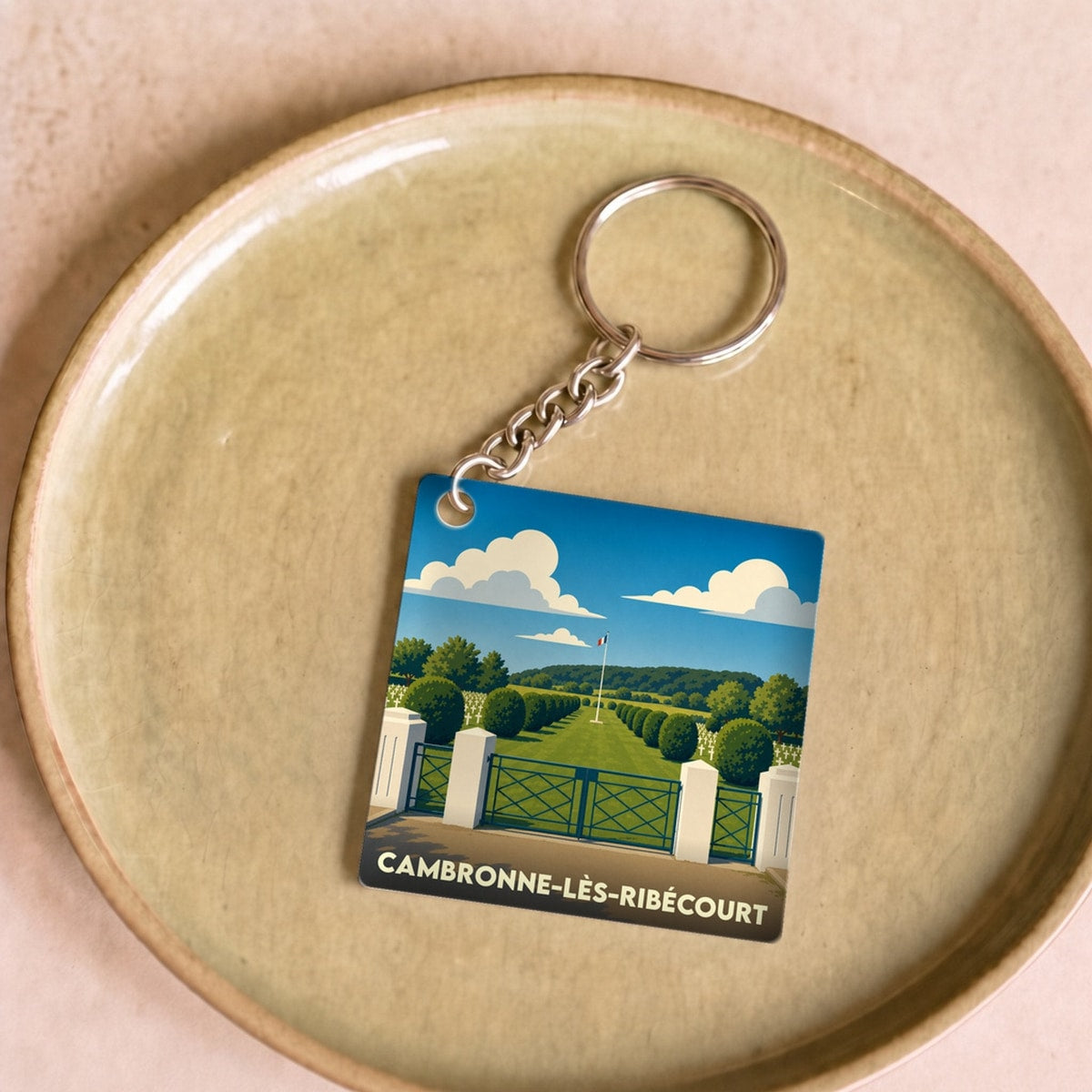 Porte-clés souvenir de la ville de Cambronne-lès-Ribécourt avec une illustration stylisée.