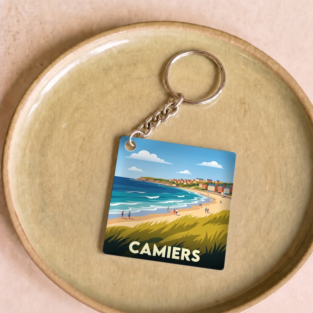 Porte-clés souvenir de la ville de Camiers avec une illustration de bord de mer stylisée.