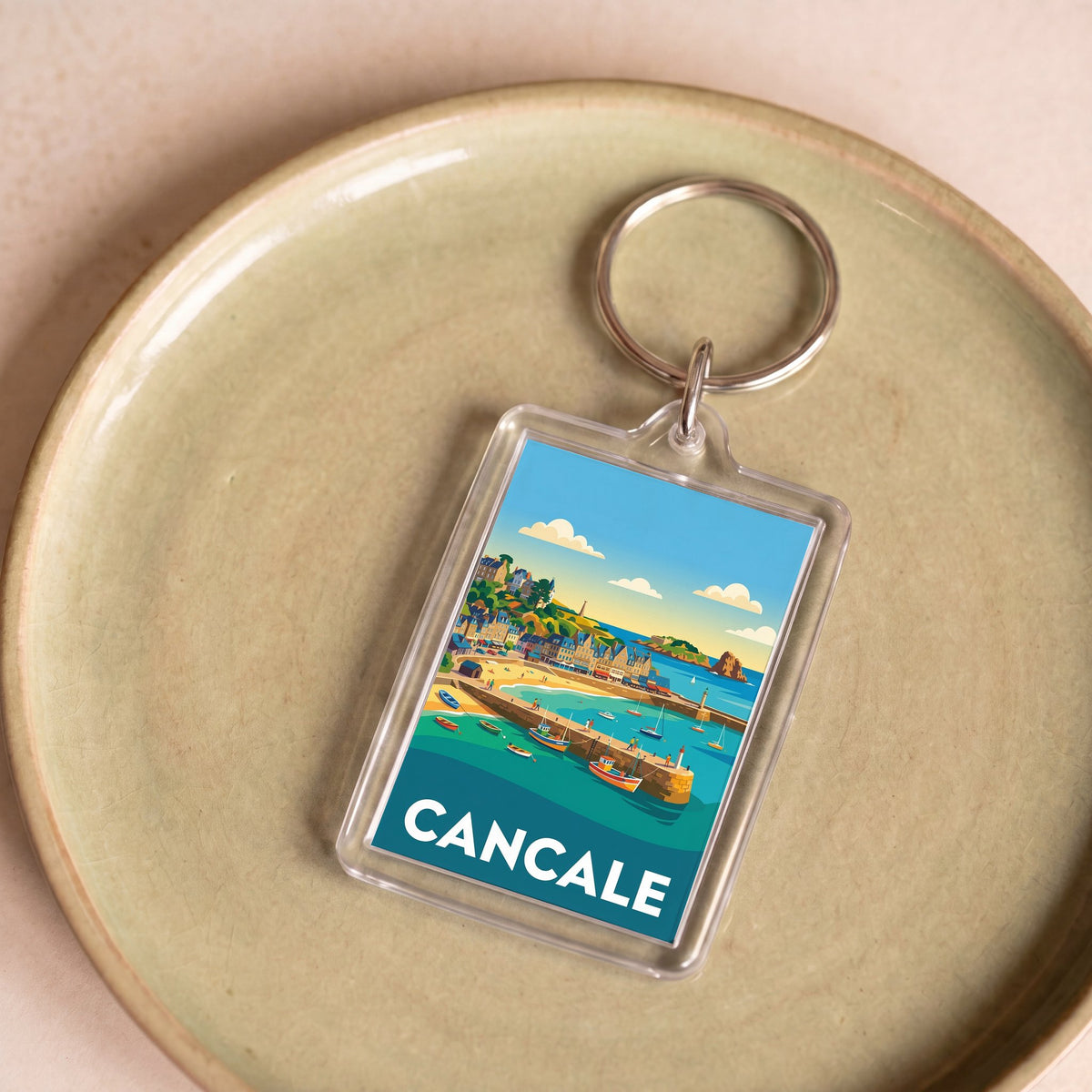 Porte-clés souvenir de la ville de Cancale avec une illustration stylisée et colorée.