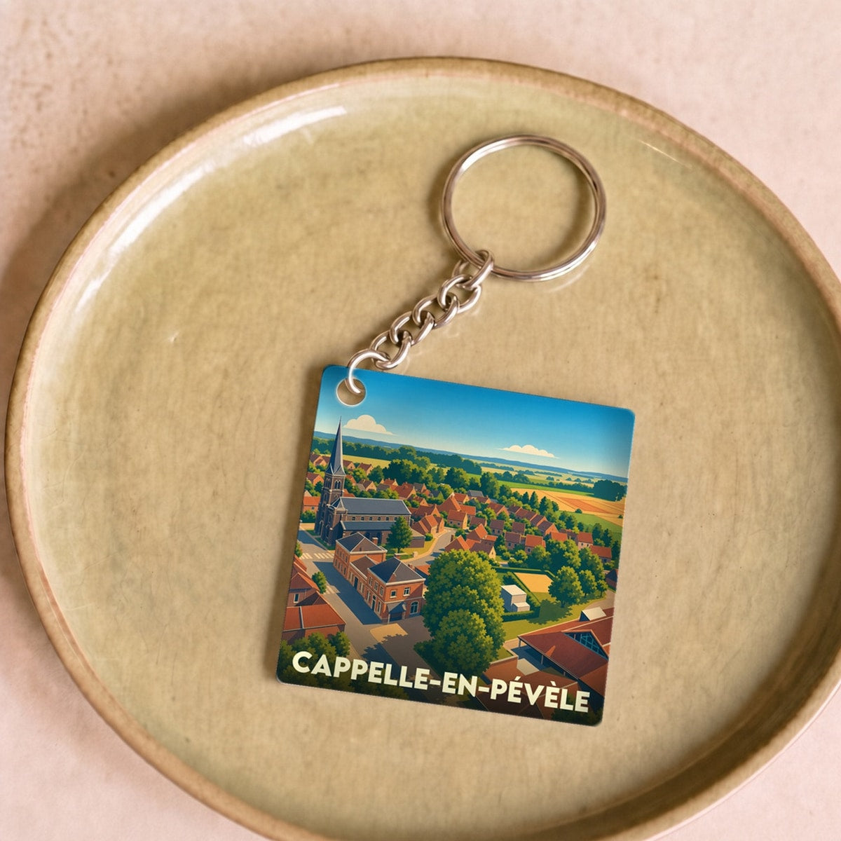 Porte-clés souvenir de la ville de Cappelle-en-Pévèle avec une illustration stylisée.