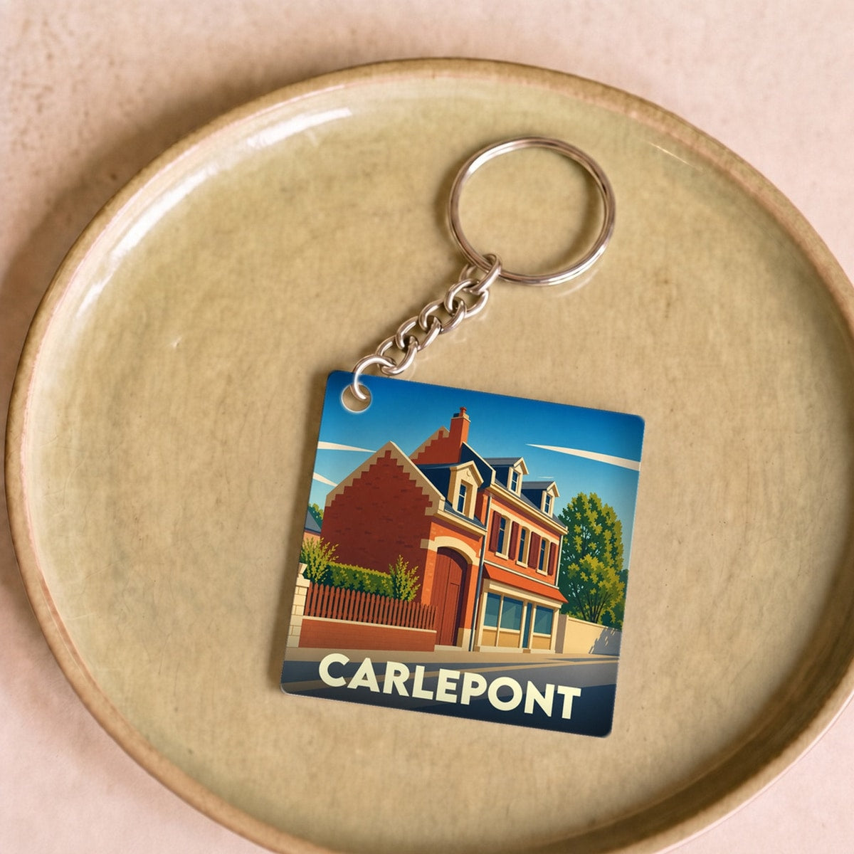 Porte-clés souvenir de la ville de Carlepont avec une illustration stylisée.