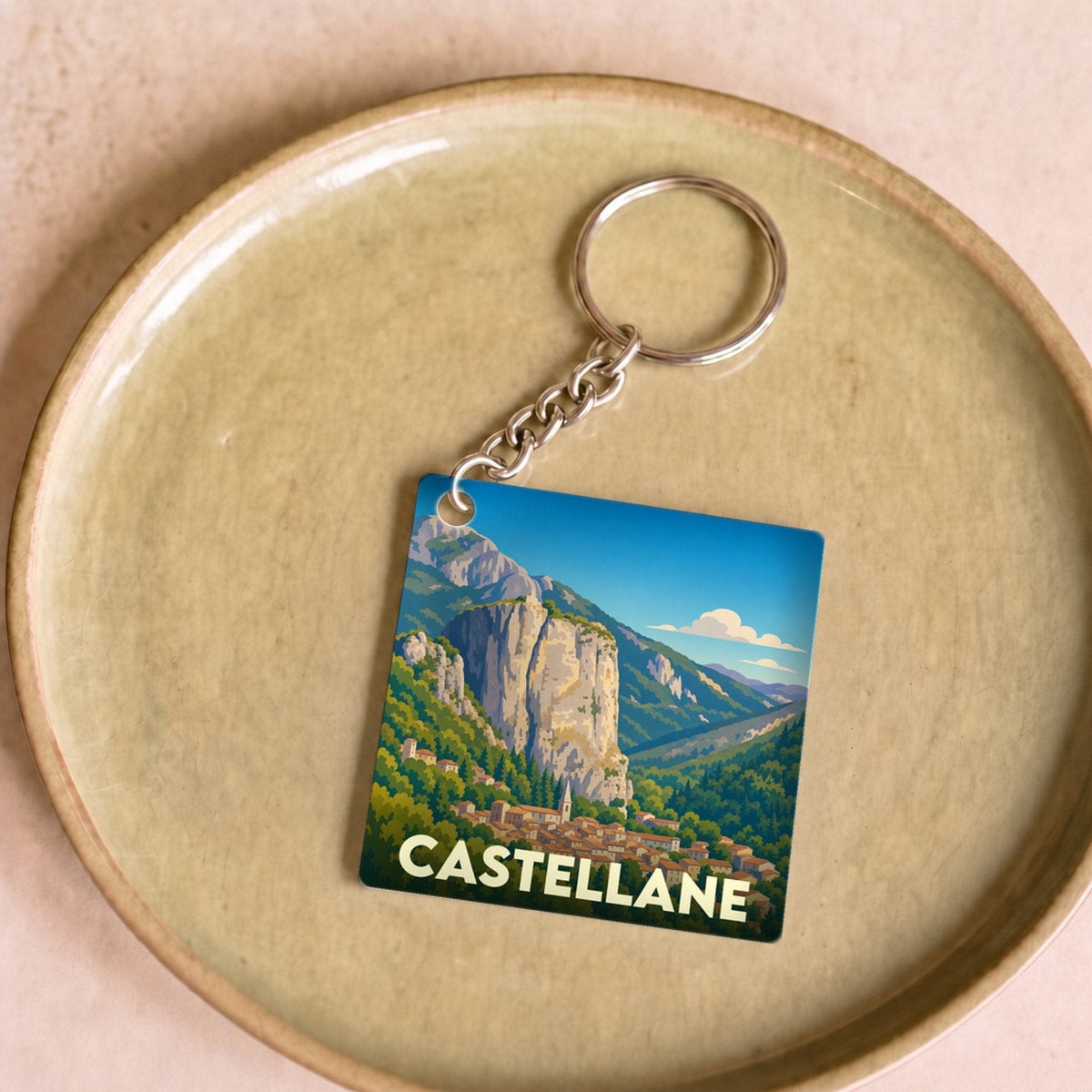 Porte-clés souvenir de la ville de Castellane avec une illustration stylisée de son célèbre rocher.