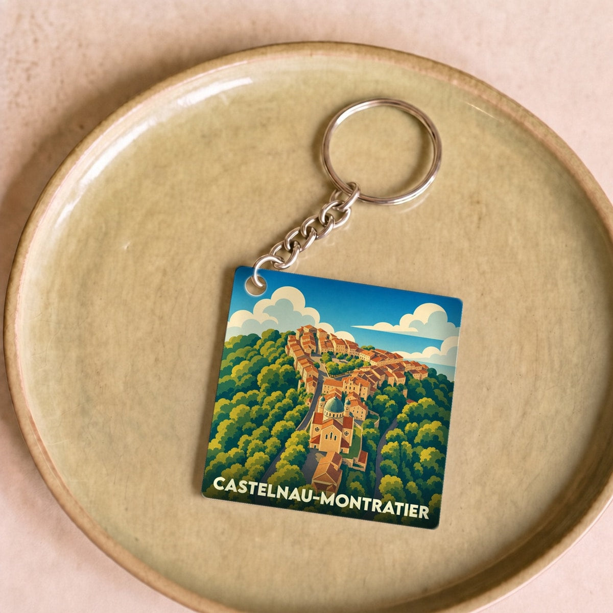 Porte-clés souvenir de la ville de Castelnau-Montratier avec une illustration stylisée.