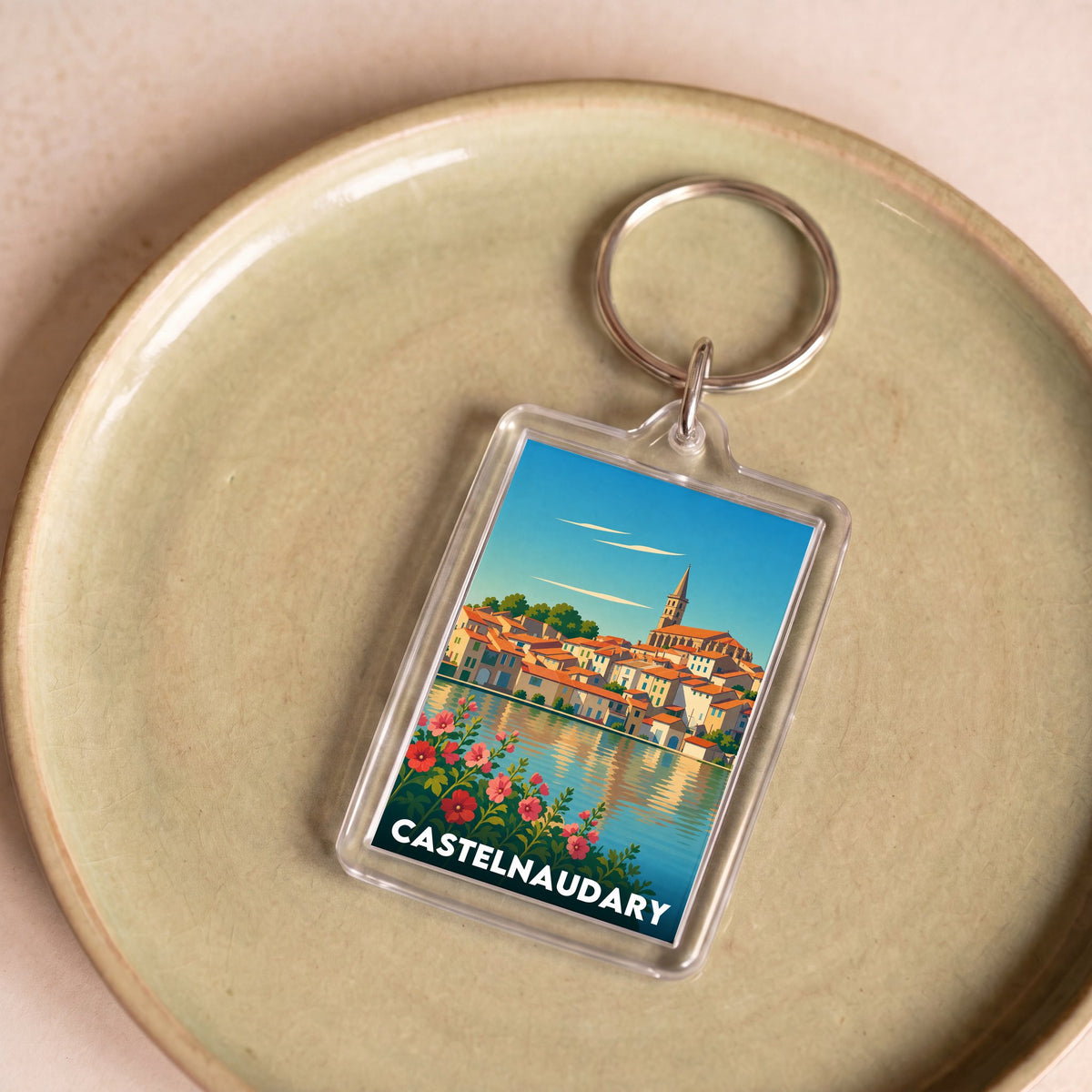 Porte-clés souvenir de la ville de Castelnaudary avec une illustration stylisée.
