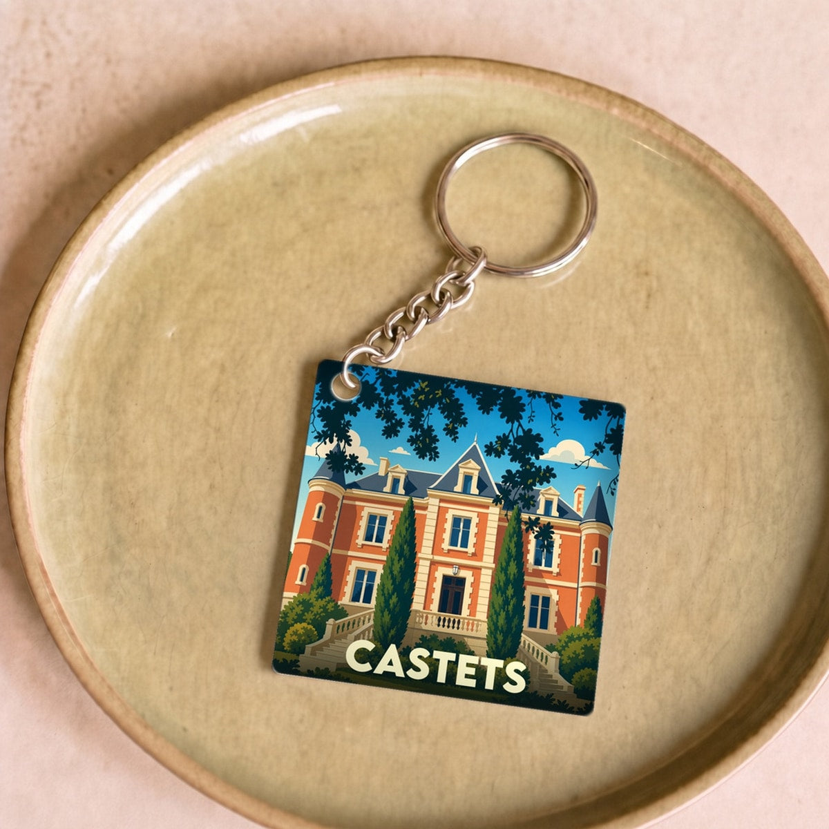 Porte-clés souvenir de la ville de Castets avec une illustration stylisée de son château.