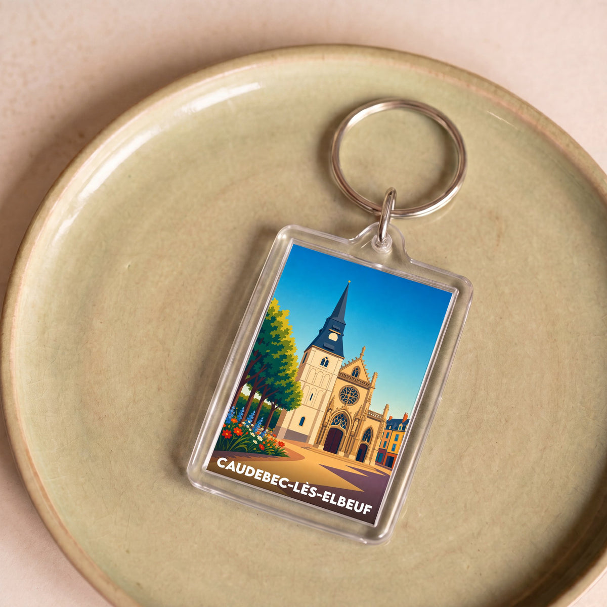 Porte-clés souvenir de la ville de Caudebec-lès-Elbeuf avec une illustration stylisée.