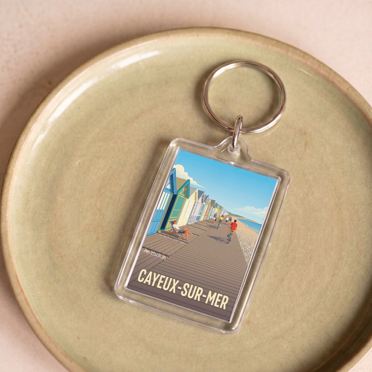 Porte-clés souvenir de la ville de Cayeux-sur-Mer avec une illustration stylisée.