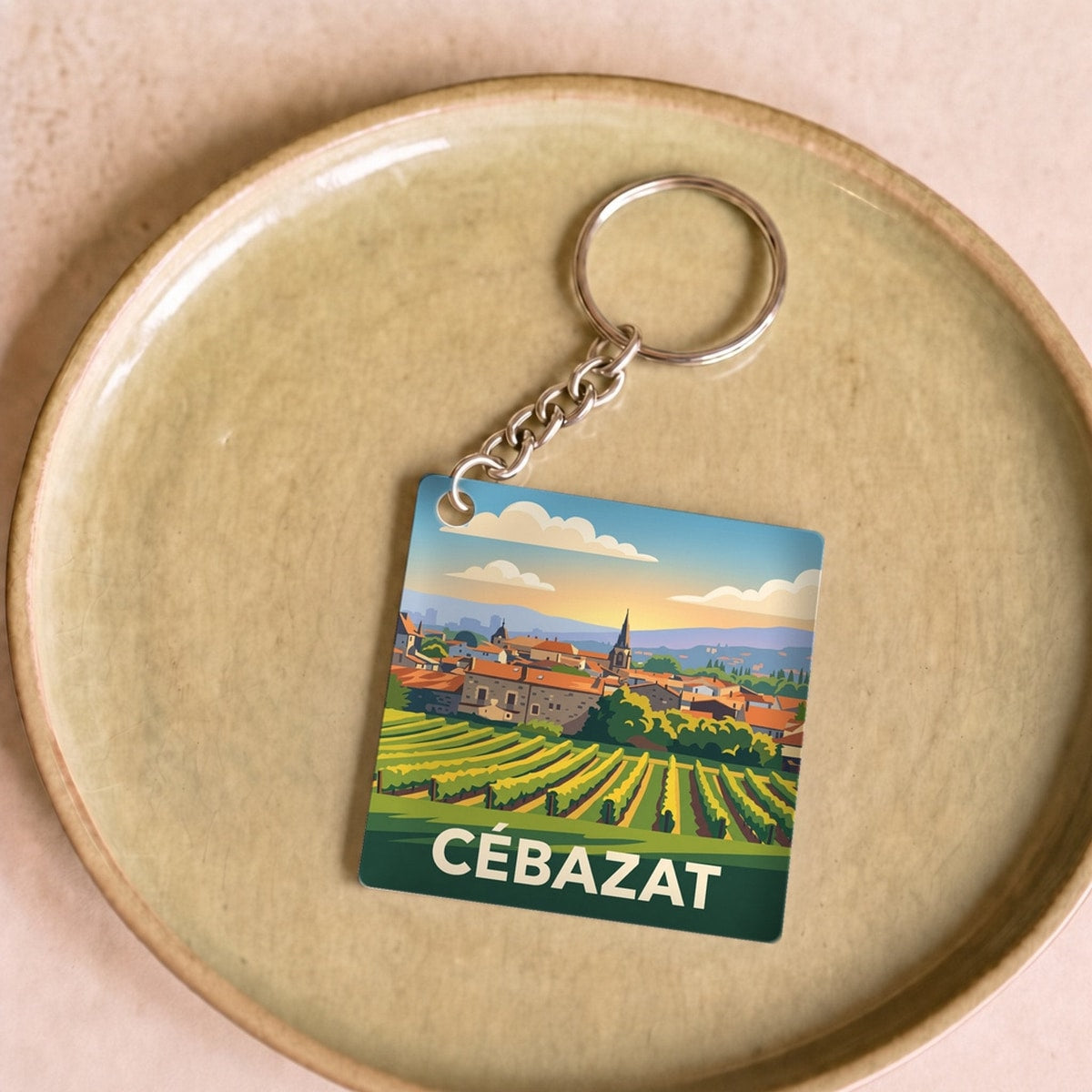 Porte-clés souvenir de la ville de Cébazat avec une illustration stylisée.