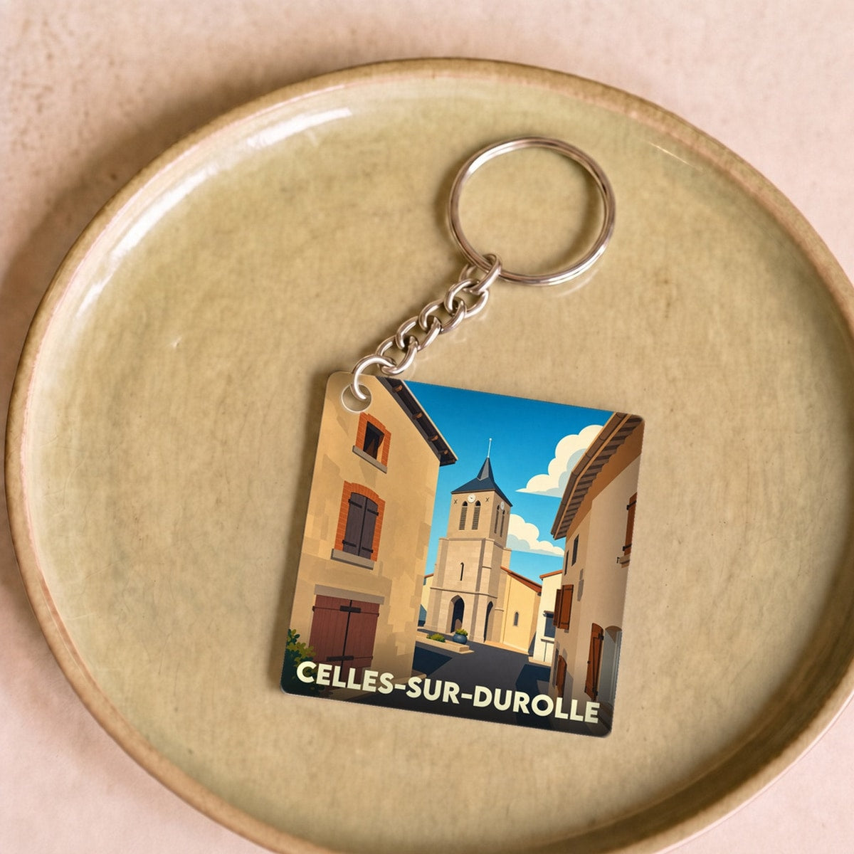 Porte-clés souvenir de la ville de Celles-sur-Durolle avec une illustration stylisée.