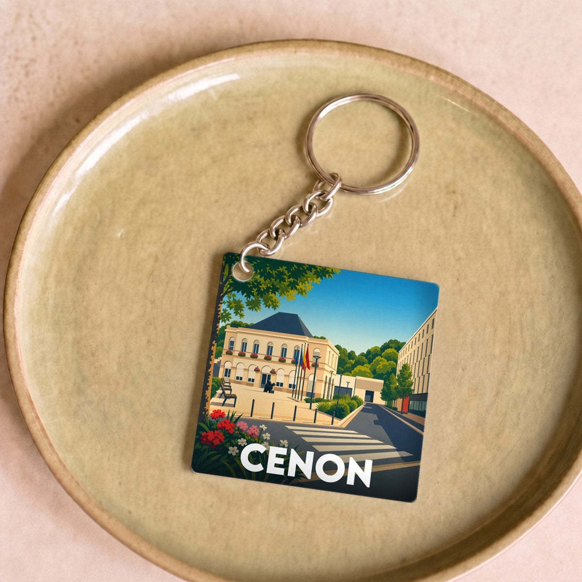 Porte-clés souvenir de la ville de Cenon avec une illustration stylisée.