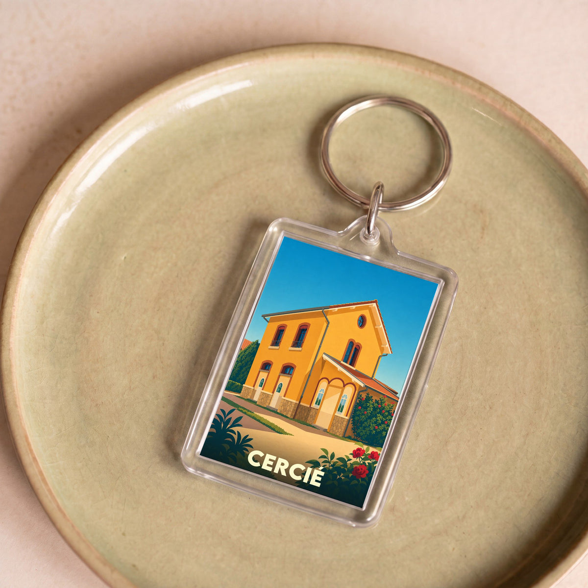 Porte-clés souvenir de la ville de Cercié avec une illustration stylisée.