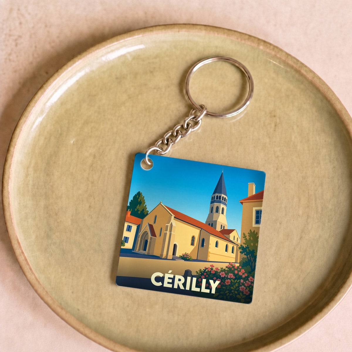 Porte-clés souvenir de la ville de Cérilly avec une illustration stylisée de son église.