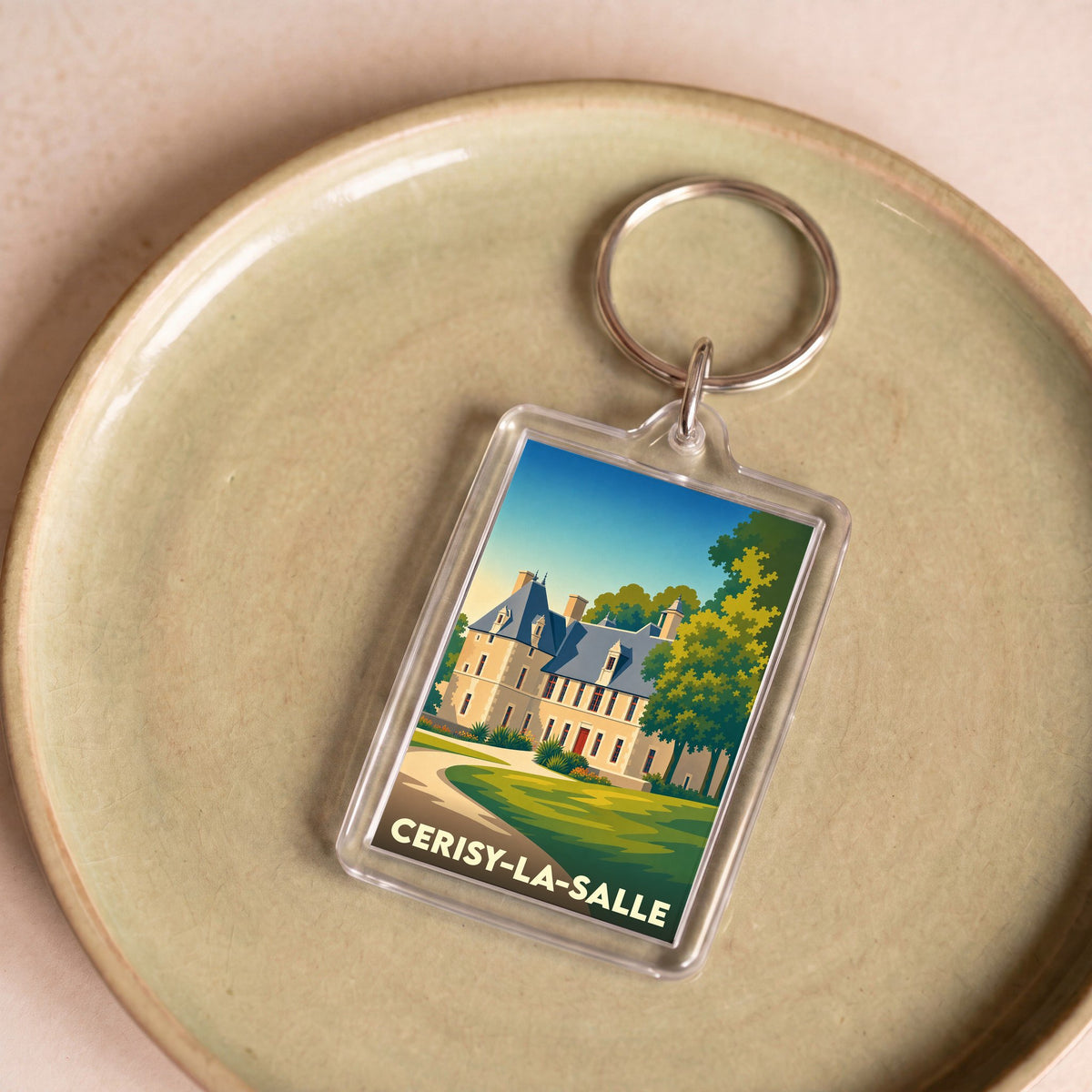 Porte-clés souvenir de la ville de Cerisy-la-Salle avec une illustration stylisée du château.