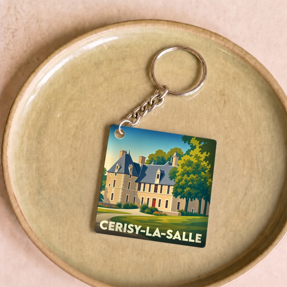 Porte-clés souvenir de la ville de Cerisy-la-Salle avec une illustration stylisée du château.
