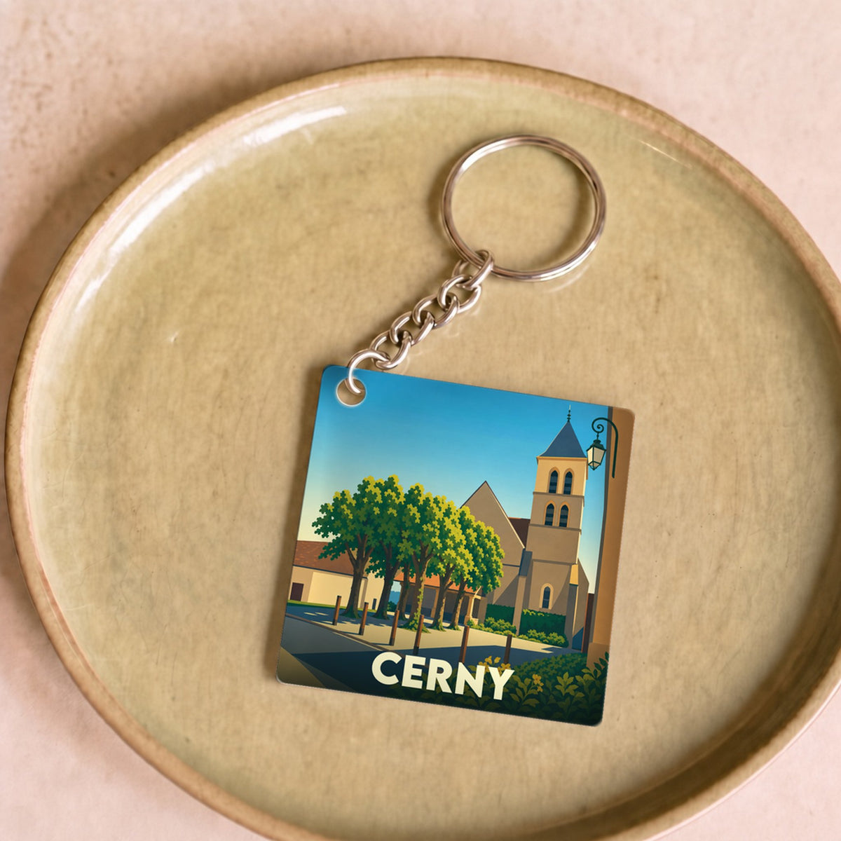 Porte-clés souvenir de la ville de Cerny avec une illustration stylisée.