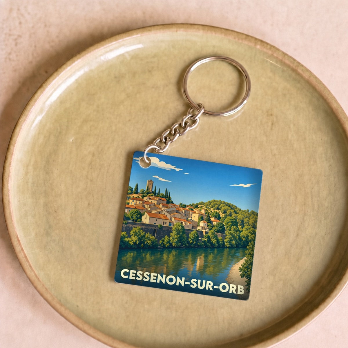 Porte-clés souvenir de la ville de Cessenon-sur-Orb avec une illustration stylisée.