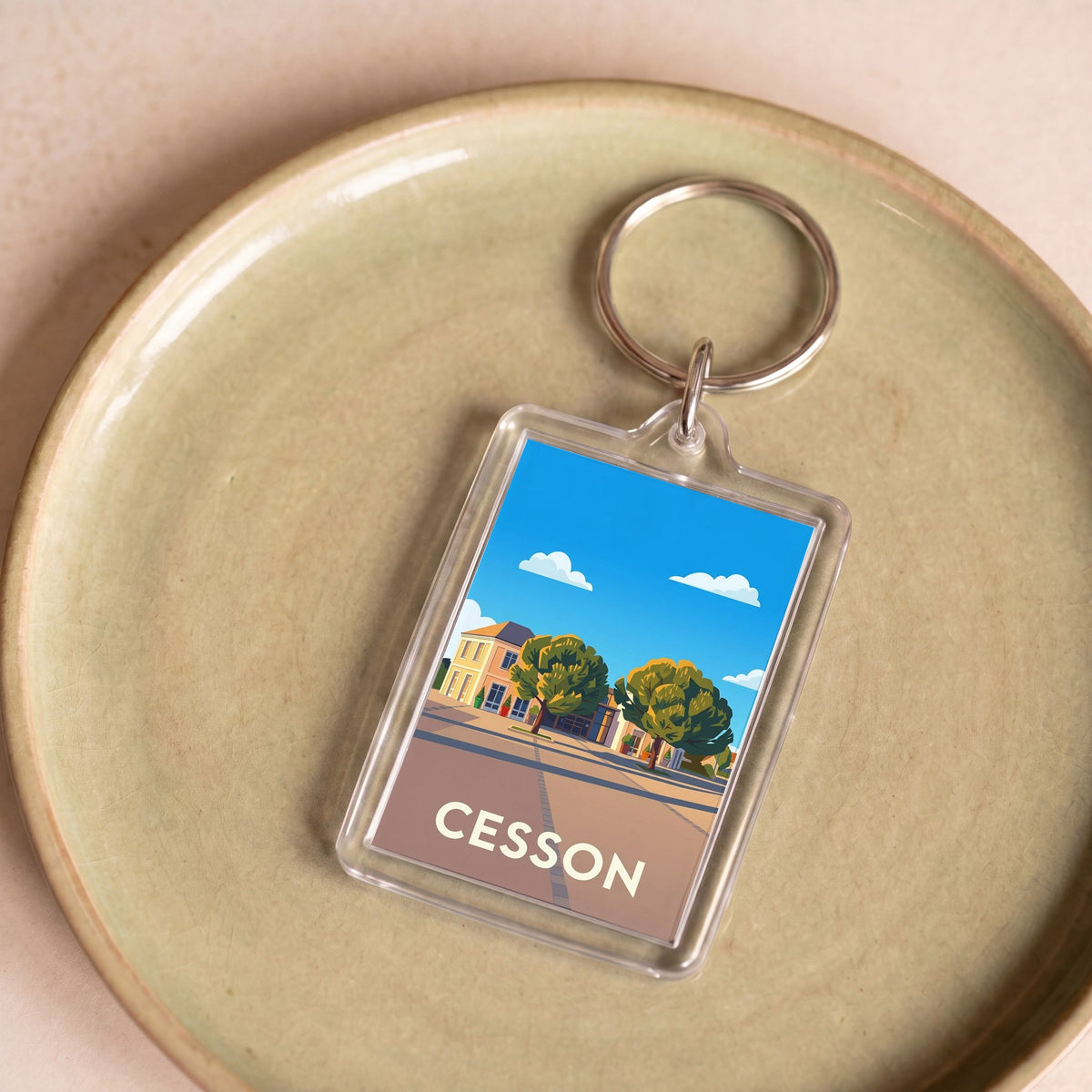 Porte-clés souvenir de la ville de Cesson avec une illustration stylisée.