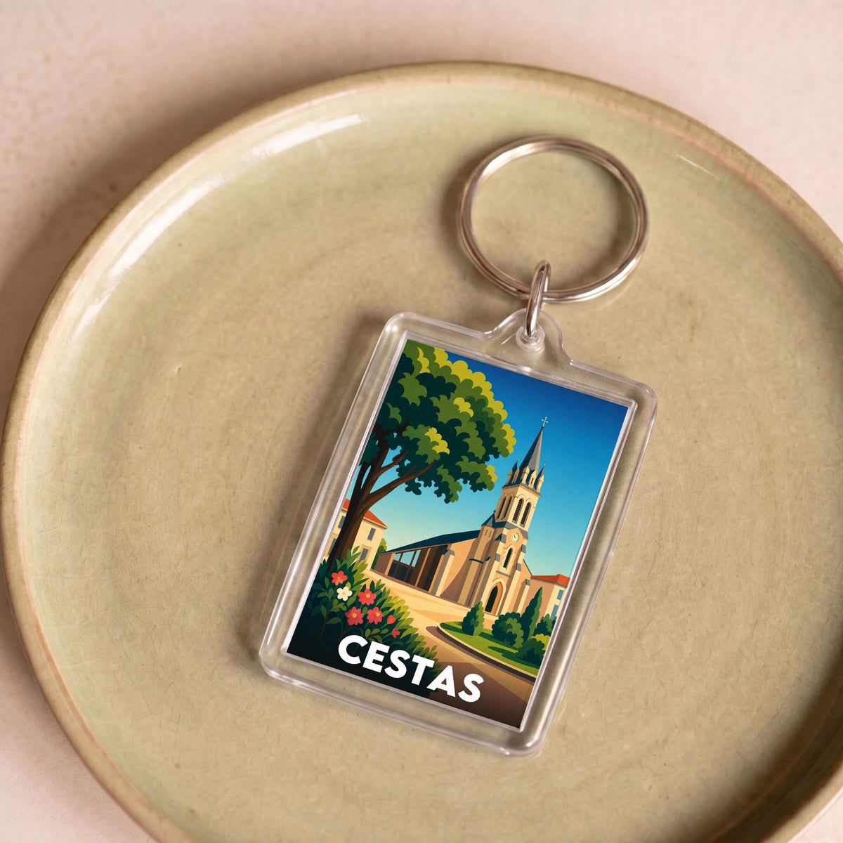 Porte-clés souvenir de la ville de Cestas avec une illustration stylisée.