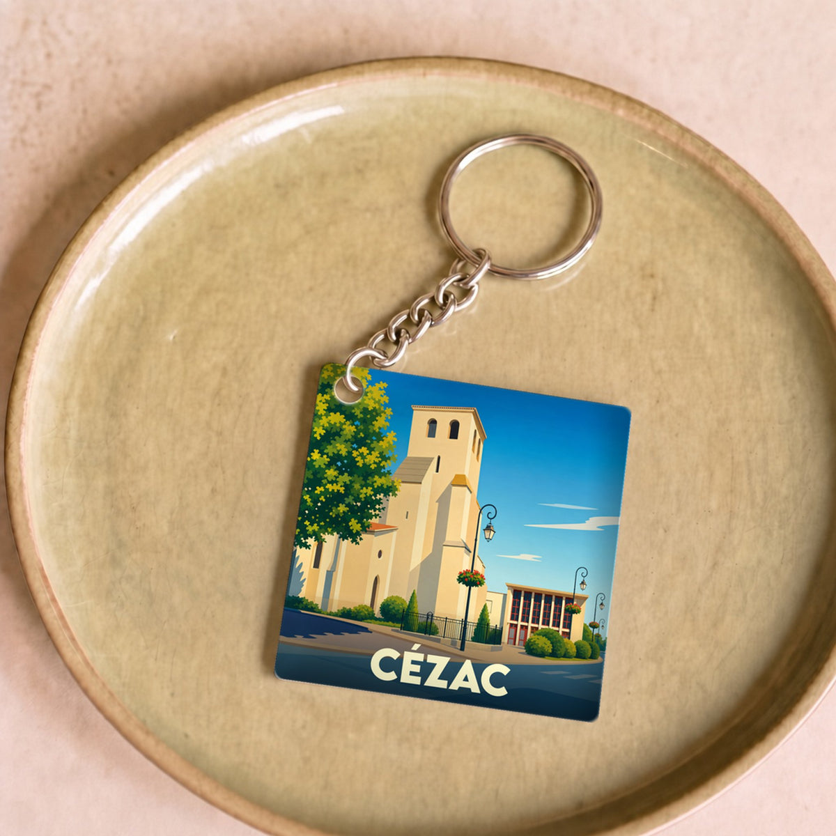 Porte-clés souvenir de la ville de Cézac avec une illustration stylisée.