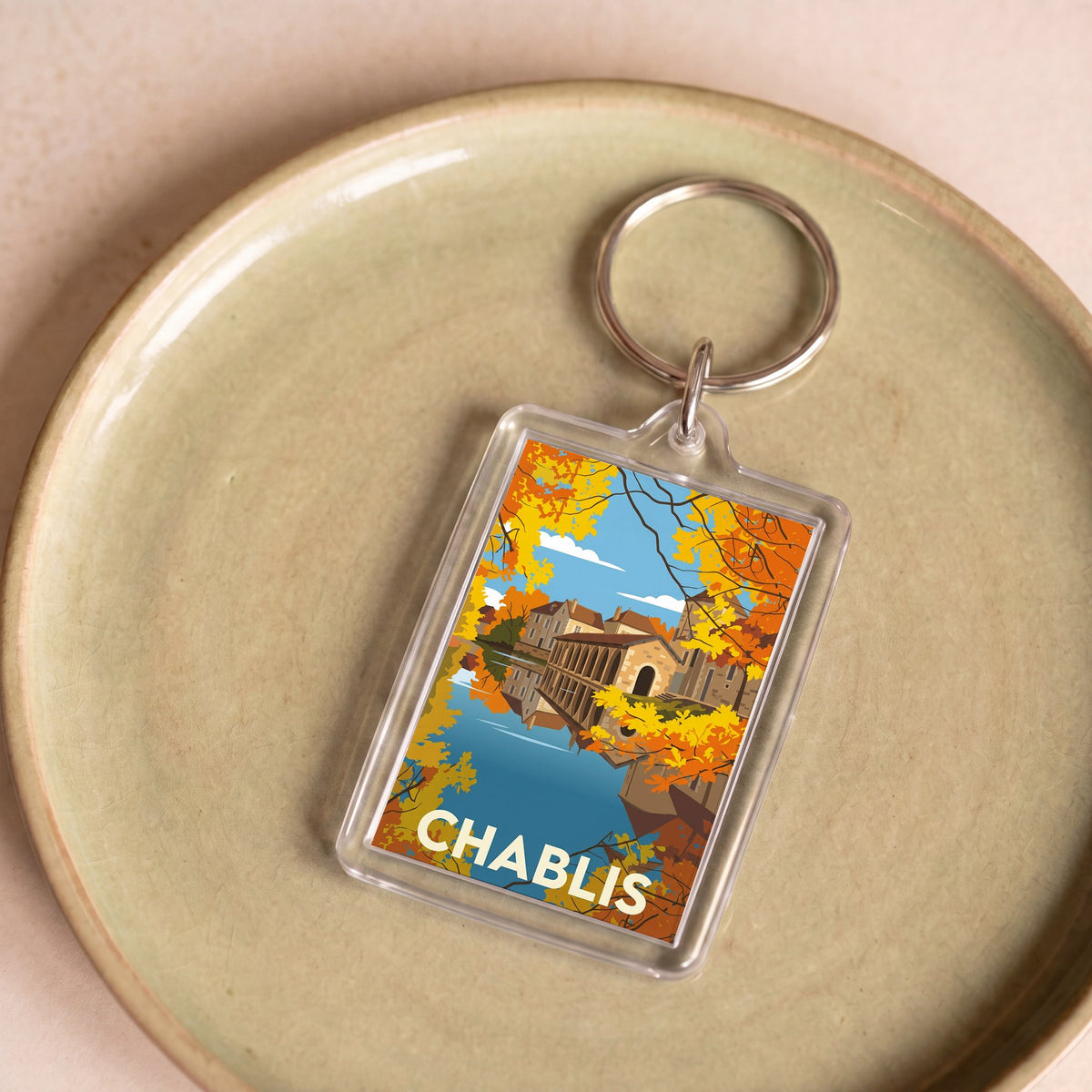 Porte-clés souvenir de la ville de Chablis avec une illustration stylisée.