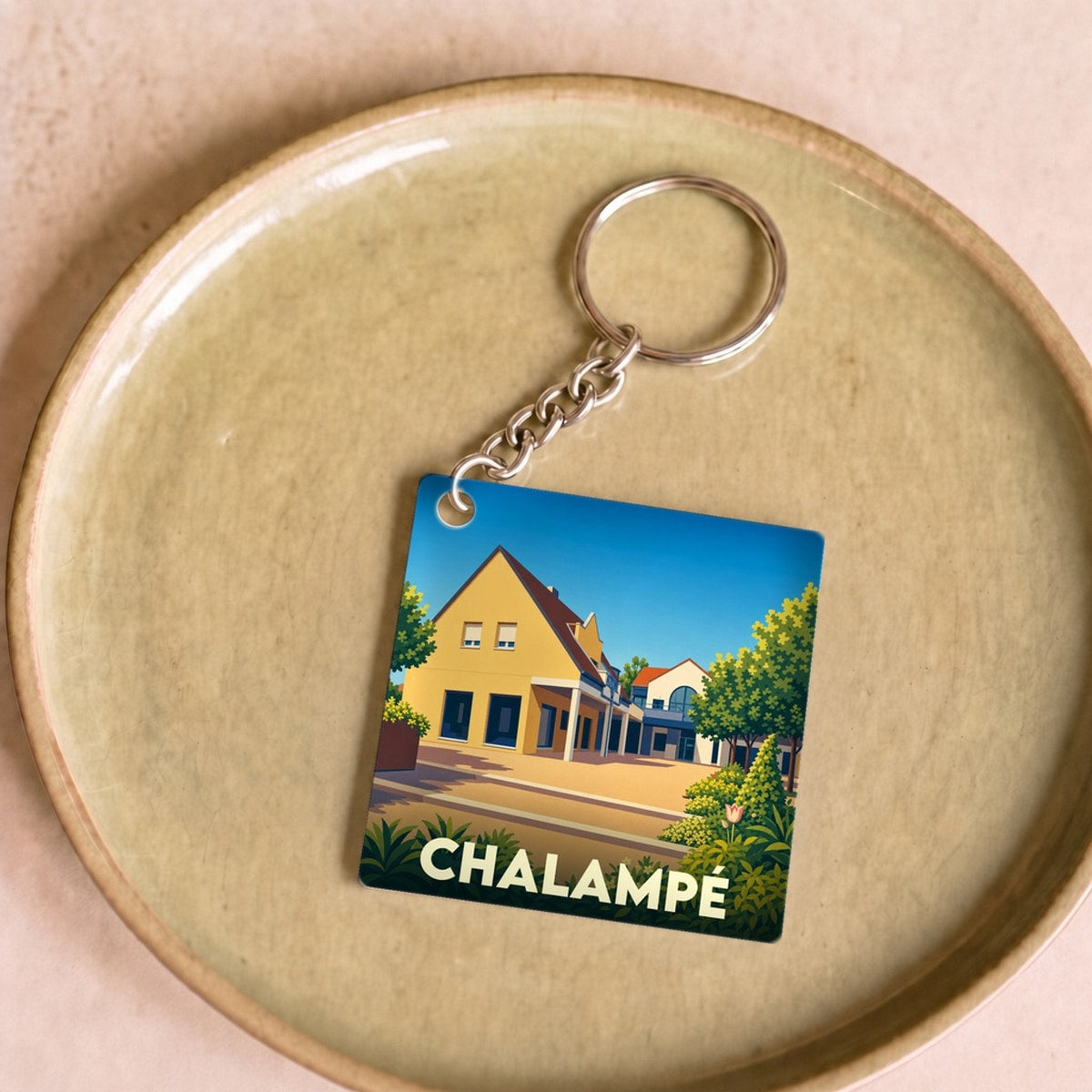 Porte-clés souvenir de la ville de Chalampé avec une illustration stylisée.