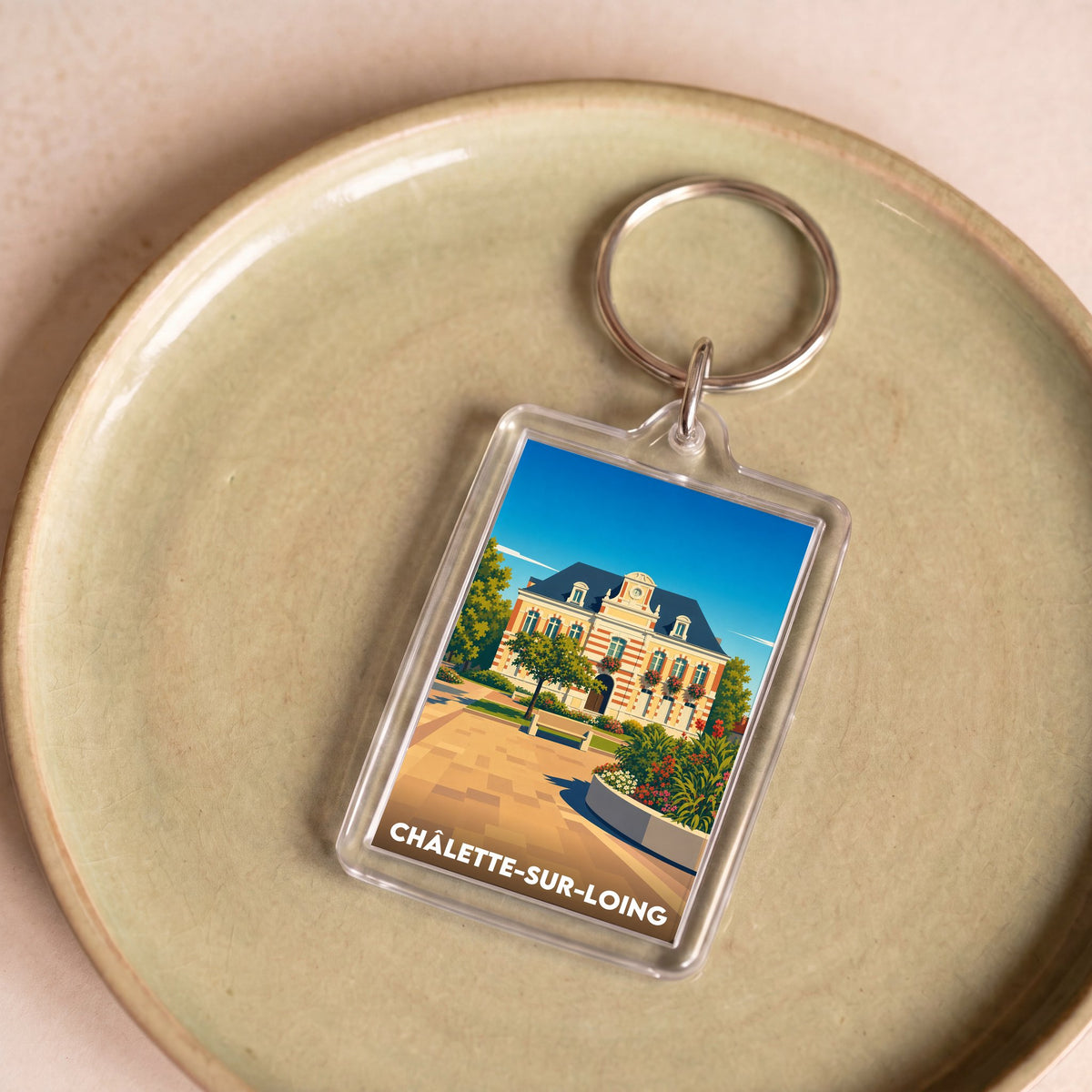 Porte-clés souvenir de la ville de Châlette-sur-Loing avec une illustration stylisée.