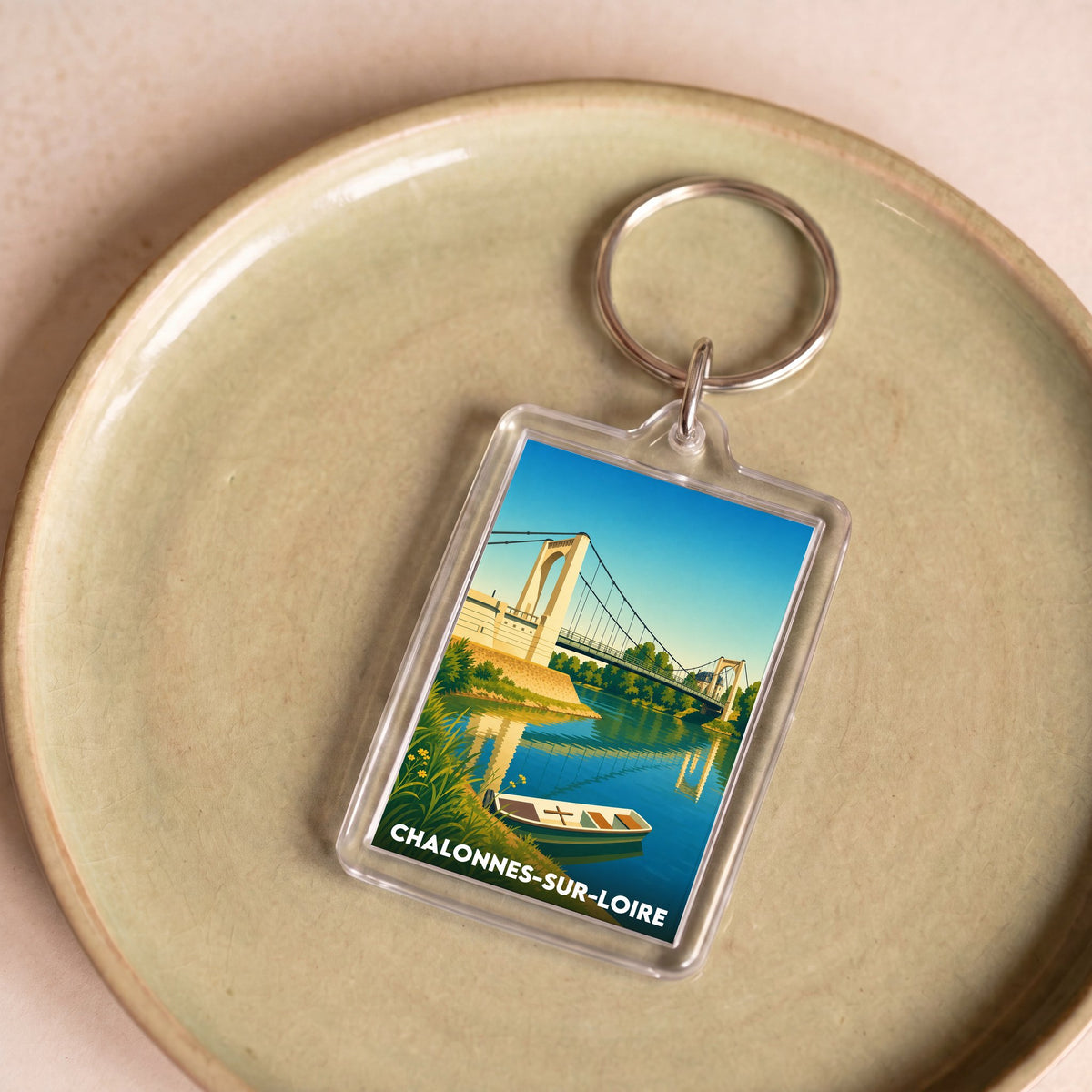 Porte-clés souvenir de Chalonnes-sur-Loire orné d'une illustration stylisée du pont franchissant la Loire.