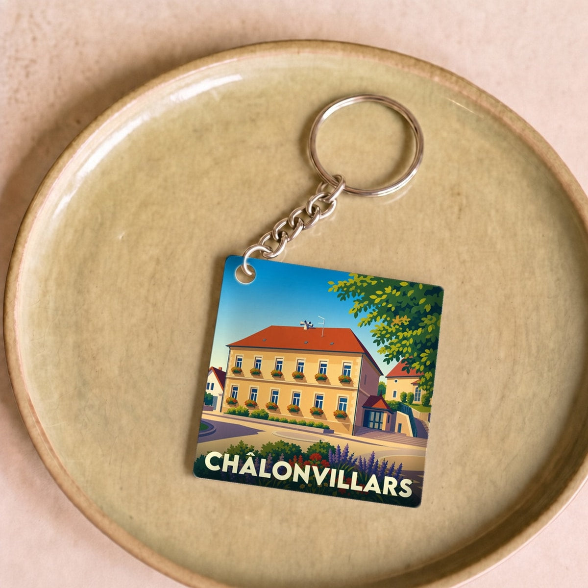 Porte-clés souvenir de la ville de Châlonvillars avec une illustration stylisée.
