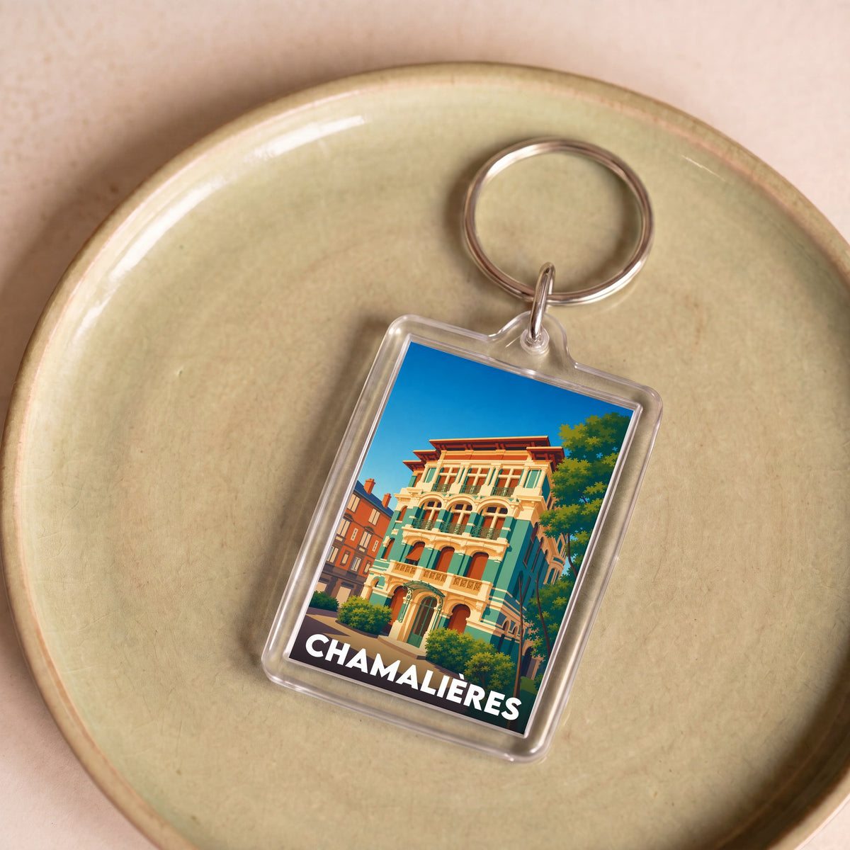 Porte-clés souvenir de la ville de Chamalières avec une illustration stylisée.